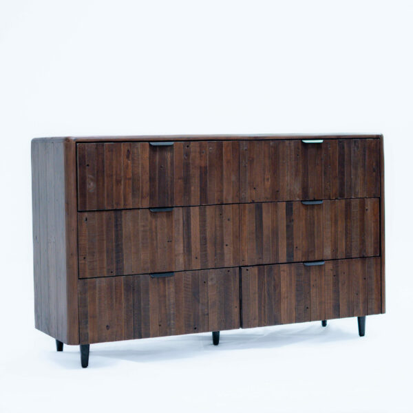 A modern wooden dresser with a dark brown finish featuring a six-drawer design with black metal handles. The dresser stands on four slightly tapered black legs, and the wood grain is visible, adding texture and character. The background is a plain white surface.